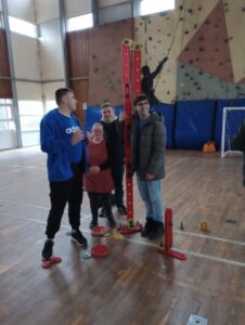 A group of young learners arranging sporting and climbing equipment