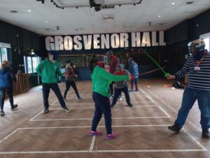 A group of staff and learners trying out an Olympic sport - fencing!