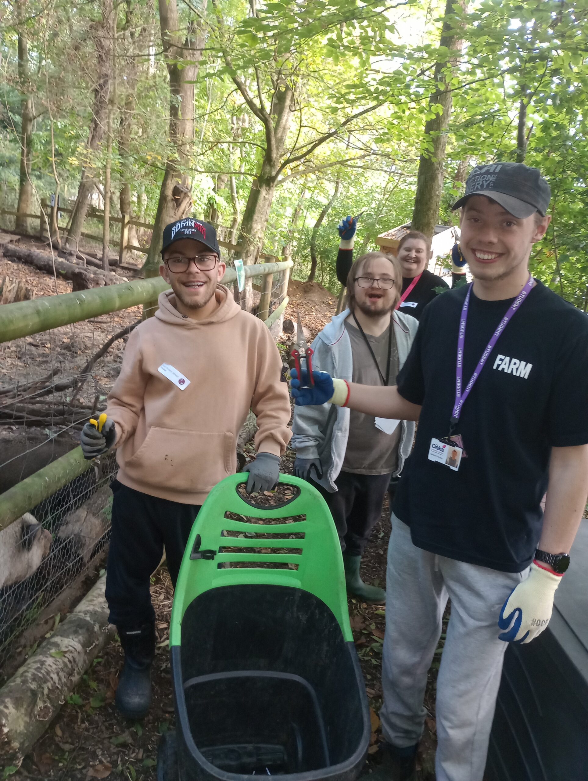 A group of smiling people with gardening tools