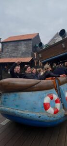 A group of young people on a boat-themed adventure park ride