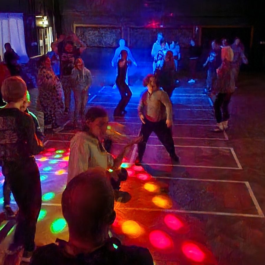 People dancing at a disco with bright lights